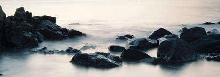 Long exposure of river and rocks at the beach in Hong Kong during sunset magic hour
