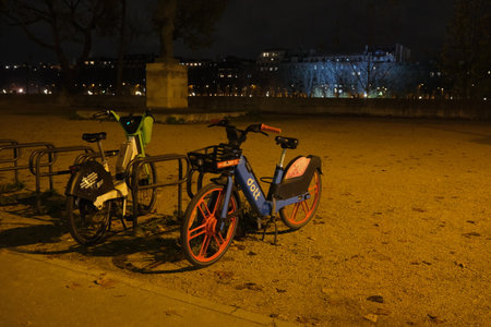 Paris - 28 Nov 2023: City Cycling: Evening Scene of Rental Bikes Parked on Paris Streets