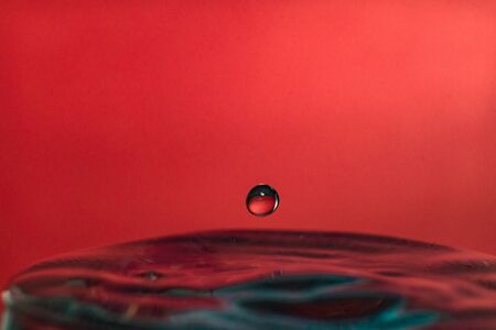Water splash isolated on red background, water bubble, detailed picture, natural elements.