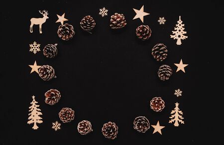 wooden winter elements, snowflakes, trees, pine cone and reindeer isolated on black background, beautiful christmas decoration, empty space for text, social media christmas bannerの写真素材