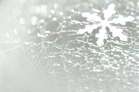 Christmas and New Year. Snowflake against the background of cracked ice. Christmas festive backgroundの写真素材