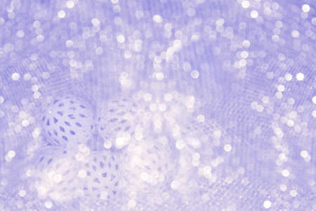 A Christmas and New Year glowing garland with white balls lies on a table covered with a cloth.の写真素材