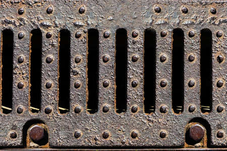 Rusty metal sewer grate close-up.の写真素材