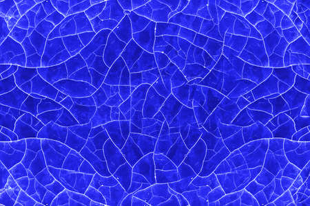 Cracked white blue paint of old age on a wooden surface.の写真素材