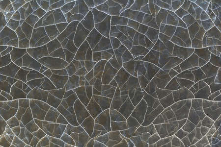 Cracked brown paint of old age on a wooden surface.の写真素材