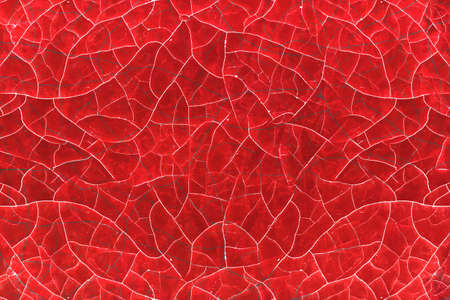 Cracked red paint of old age on a wooden surface.の写真素材