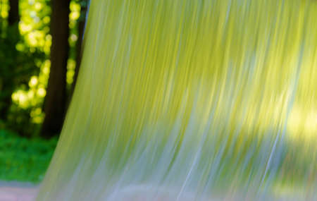 The stream of flowing water against the backdrop of the forest.の写真素材