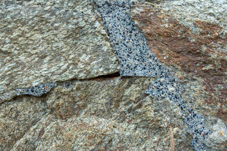 Multi-colored stone wall texture with various building materialsの写真素材