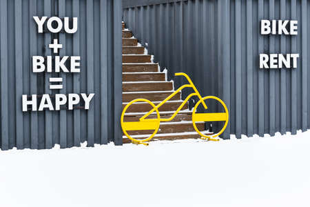 A bright yellow bicycle blocks the entrance to the stairs going up.の写真素材