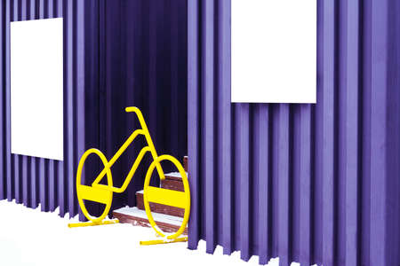On the walls of garages hang white shields, between which stands a bicycle and blocks the entrance to the stairs.の写真素材