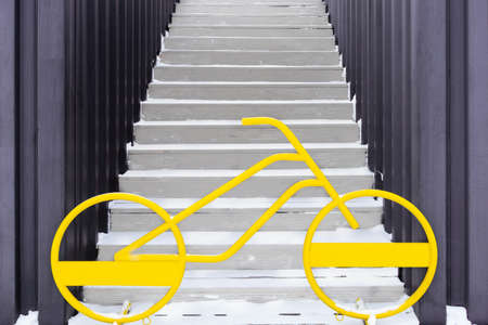 Riding a bike is safer than walking on icy stairs.の写真素材