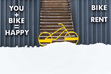 A bright yellow bicycle blocks the entrance to the stairs going upの写真素材