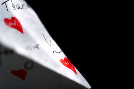 On a black background is a white note with red hearts on which the words of gratitude are writtenの写真素材