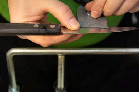 Setting the sharpening angle on the knife holderの写真素材