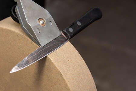 The correct position of the knife holder and the knife itself on the grindstoneの写真素材