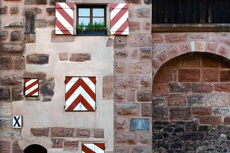 Fragment of the wall of an old building with bright shutters in the city of Nurembergの写真素材