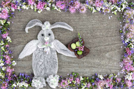 The composition of the rabbit from the leaves of the flower Stakhis and the frame of flowers Spirea and Veronicaの写真素材