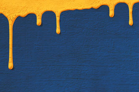 Background with texture of concrete stucco wall in blue on which drops yellow paint flows down. Concept texture, background, repair, color 2020.の写真素材