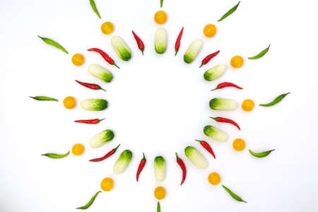 Top view flat lay over cucumbers, cherry tomatoes and peppers on a white background with copy space. Food template food design menu background with culinary ingredientsの写真素材