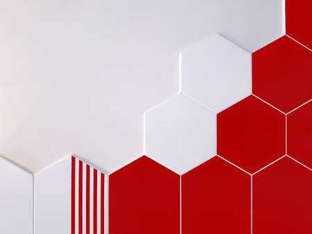 A background of bright red and white ceramic tiles in the shape of a hexagon that partially covers a white wall. Concept texture, backgroundの写真素材