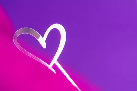 View of a mirrored white heart on a background of purple and pink. Holiday concept, Valentine's Day, art, background, loveの写真素材