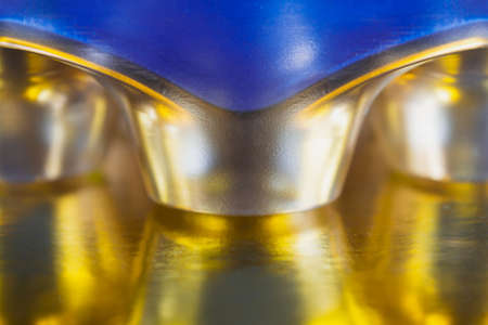 Abstract background of coffee capsules of gold color that are reflected on the surface. Concept abstraction, background.の写真素材