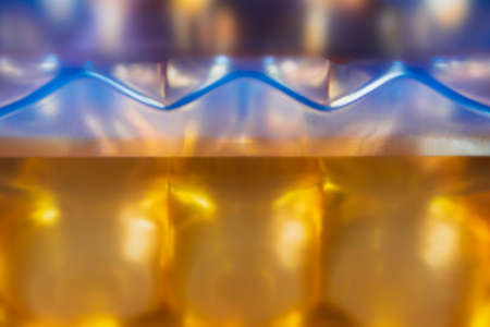 Abstract background with a zigzag line of violet color on a blurred background of gold color. Concept background, textureの写真素材
