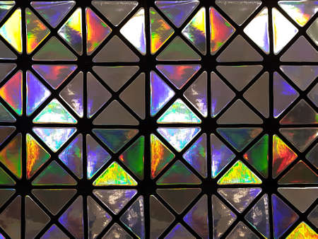 Graphic pattern in the form of a mosaic of triangles with a shiny glossy surface in neon colors. Concept background, abstractionの写真素材
