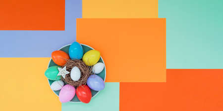 Bright background with a non-symmetrical geometric pattern in a fashionable color scheme with a composition of their Easter eggs and stars that lie on a plate. Concept background, holiday, easterの写真素材