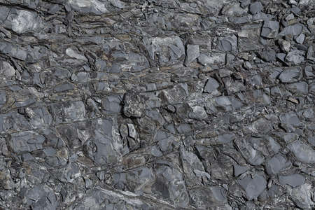 The texture of the stone surface of the mountain with minerals in monochrome colors of black and...