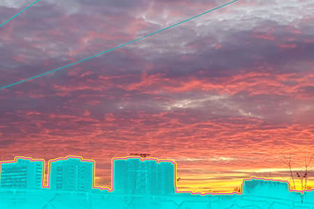 Contemporary art collage. City view against the sky with thick clouds at sunset in bright orange and purple tones. Concept landscape, city, backgroundの写真素材