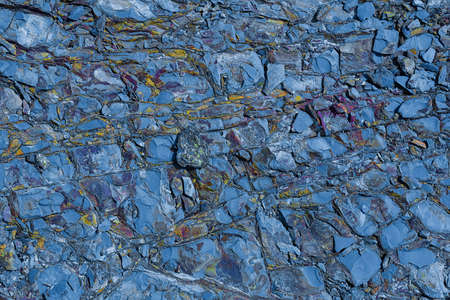The texture of the stone surface of the mountain with minerals of different colors. Concept background, textureの写真素材