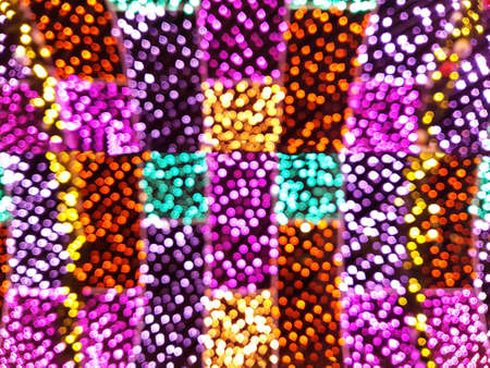 Bright background from blurry bokeh of Christmas lights of different colors. Holiday concept, background, christmasの写真素材
