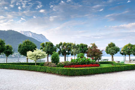 View of the embankment on the lake against the backdrop of mountains and blue sky with beautiful clouds. Concept landscape, landscape designの写真素材