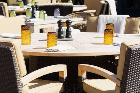 View of the served tables of the restaurant at which no one is sitting. Concept city, cafe, catering, crisisの写真素材