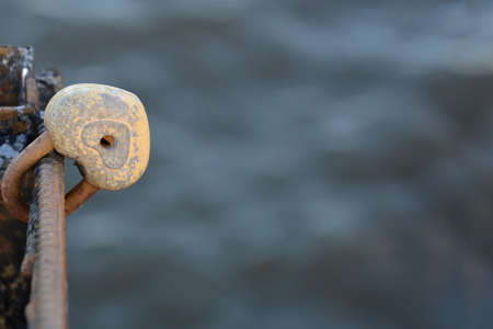 View of a metal lock in the form of a heart on a gray background. Concept landscape, background, loveの写真素材