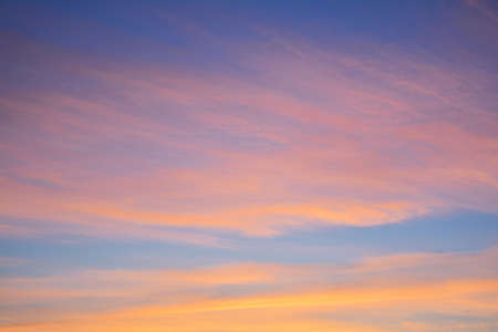 Blue sky at sunset with bright stains of orange and pink. Concept landscape, abstractionの写真素材
