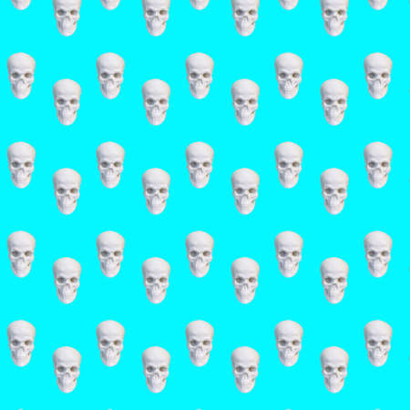 Contemporary collage. Seamless pattern of white skulls on a blue backgroundの写真素材
