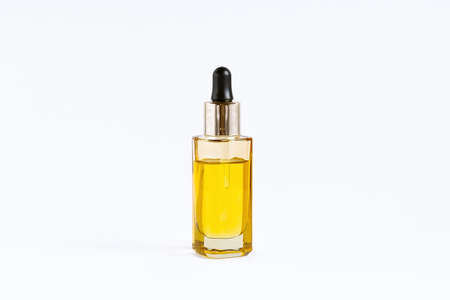 Glass bottle with a dropper with CBD oil on a white backgroundの写真素材