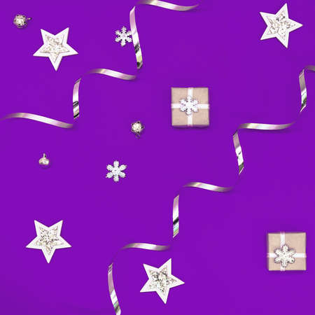 Flat composition of Christmas decorations in white and silver on a purple background.の写真素材