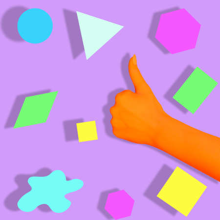 Orange human hand with like gesture on the background of geometric shapes. Back to school conceptの写真素材