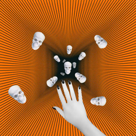 Contemporary collage. Sculptures of skulls fly into a black hole against the background of a hand with a black manicure. Death holiday concept, halloween.の写真素材