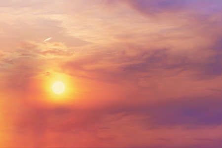 View of the bright orange halo of the sun in the evening sky at sunset. Landscape concept, backgroundの写真素材