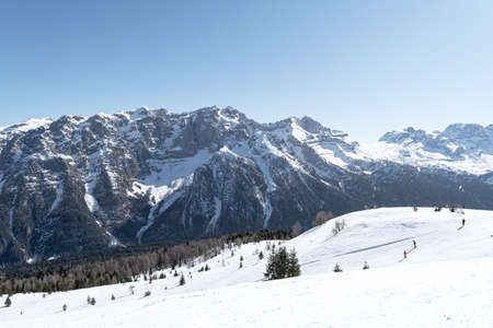 View of the ski slope in the Dolomites along which people slide down. Concept for sports, landscape, peopleの写真素材