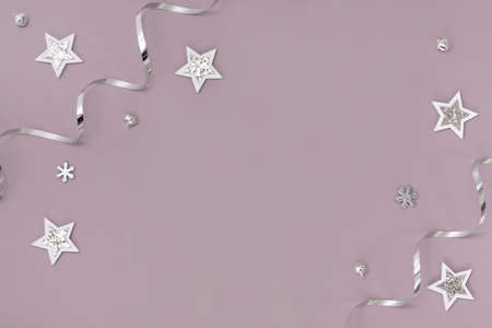 Flat composition of Christmas decorations in silver on a pink backgroundの写真素材