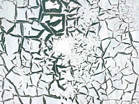 The texture of the painted wall with peeling white paint which is covered with large green cracks. Concept background, texture.の写真素材