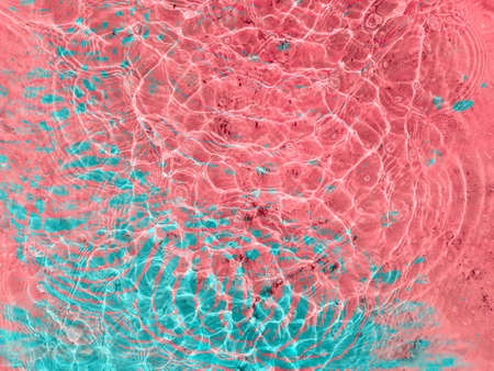 Water texture with circular streaks on the surface, bubbles and sun glare. Concept background, texture, abstraction.の写真素材