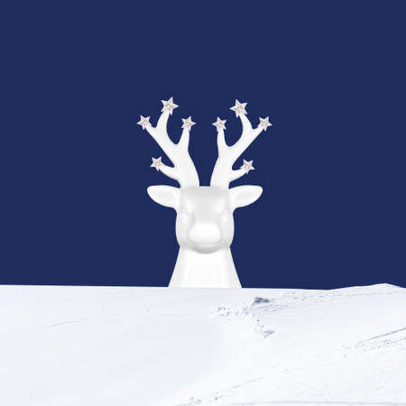 Contemporary collage. 3D illustration. Christmas background with a white deer in the snow on a blue backgroundの写真素材