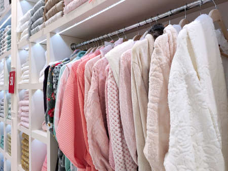 View of the bathrobes and neatly folded terry towels of various colors in the store. Concept for lifestyle, retail, discountsの写真素材
