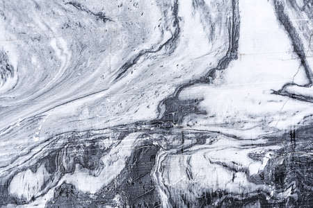 The texture of a marble rock with cracks and a pattern in the form of streaks. Concept background, texture, nature.の写真素材